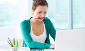 woman working on indesign white laptop