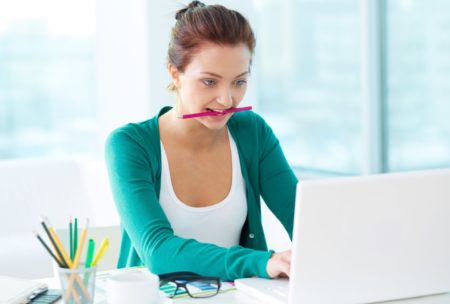 woman working on indesign white laptop