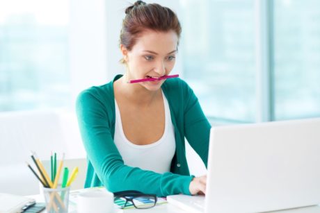 woman working on indesign white laptop