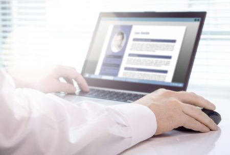 man creating cv on laptop