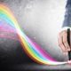 a professional in a suit uses a pen to create a vibrant rainbow line, showcasing CorelDRAW for beginners