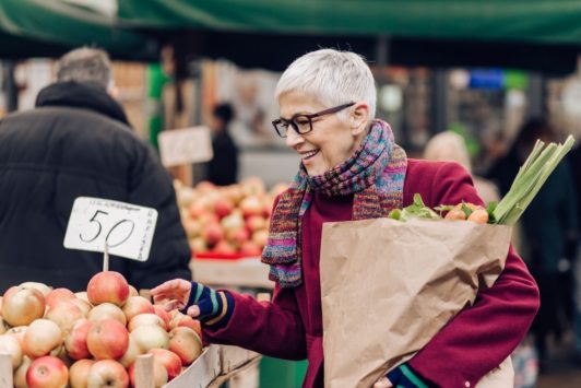 old woman shopping for apples