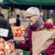 old woman shopping for apples
