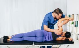 therapist treating female patient joint health