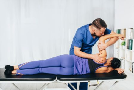 therapist treating female patient joint health