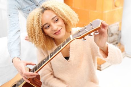 woman learning to play the guitar