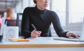 woman taking notes