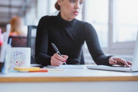 woman taking notes
