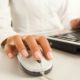 woman holding white mechanical mouse