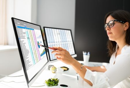 woman working with power BI on desktop computer