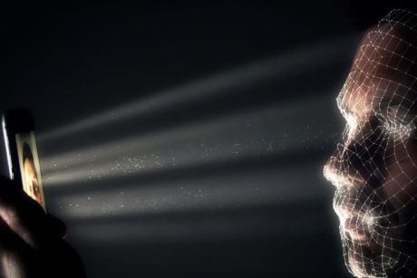 a man looks at his phone while donning a mesh mask, illustrating python optical character recognition