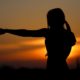 silhouette of strong woman punching