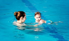 mom swimming with baby