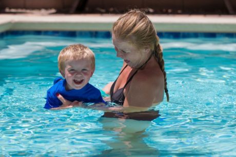 mom teaching toddler how to swim