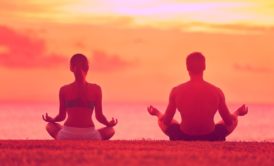 man and woman meditating