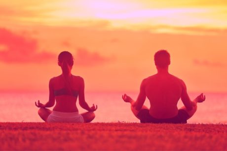 man and woman meditating