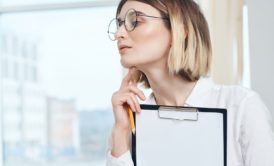 ptsd counselor holding a clipboard with white paper