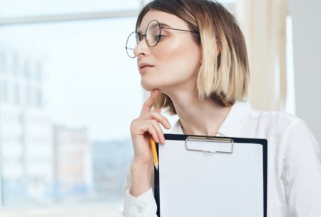 ptsd counselor holding a clipboard with white paper