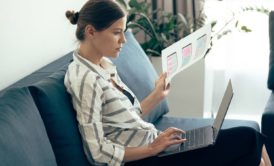 female designer using adobe xd on silver laptop