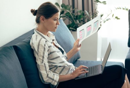 female designer using adobe xd on silver laptop