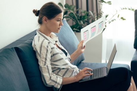 female designer using adobe xd on silver laptop