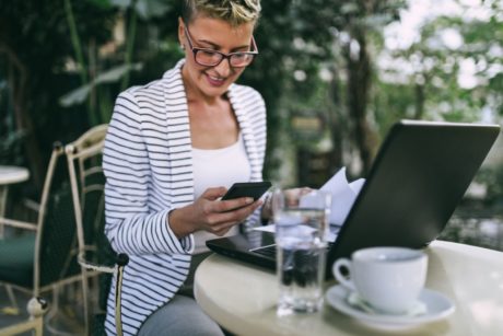 woman in striped jacket being productive