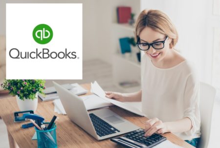 quickbooks logo and woman typing on silver laptop