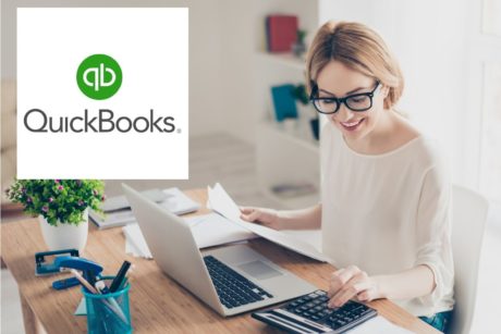 quickbooks logo and woman typing on silver laptop