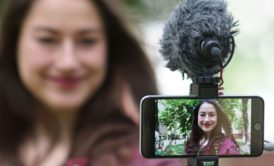 woman recording video of herself with smartphone