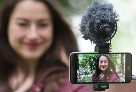 woman recording video of herself with smartphone