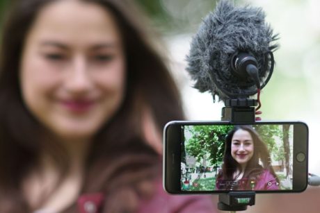 woman recording video of herself with smartphone