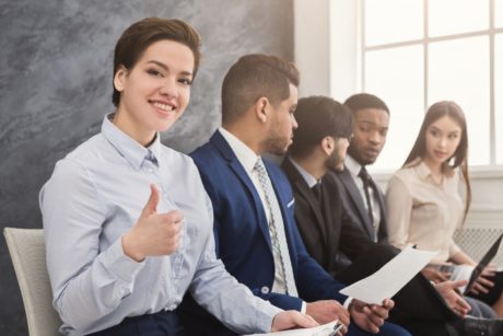 female job applicant smiling and making a thumbs up