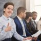 female job applicant smiling and making a thumbs up