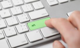person pressing a green key labeled API