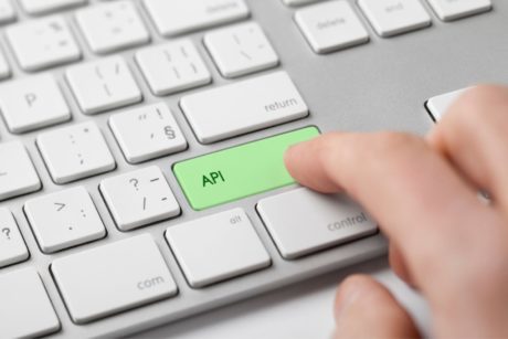 person pressing a green key labeled API