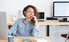 confident woman in blue shirt smiling