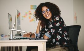 woman smiling from work desk excel magic 8