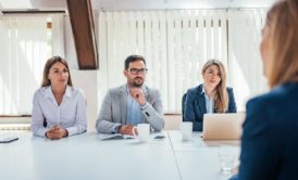 three recruiters interviewing a female job applicant