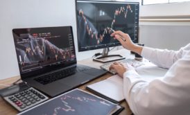 man tracking iq stock options using desktop and laptop computers