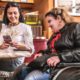 woman showing website to a handicapped person