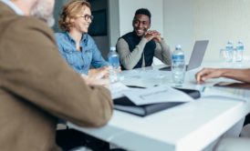 three managers talking in a meeting