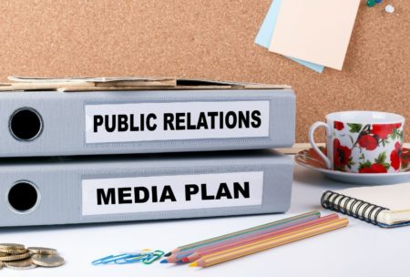 binders with labels public relations and media plan