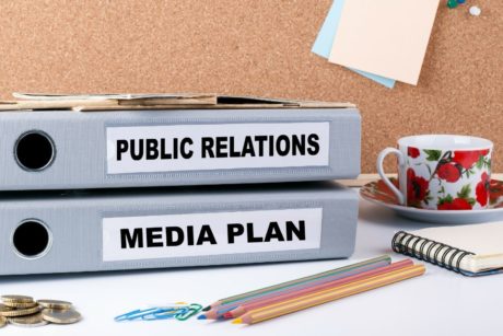 binders with labels public relations and media plan