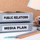 binders with labels public relations and media plan