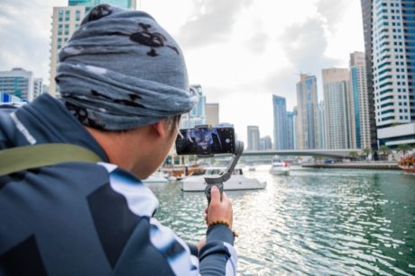 man recording a documentary with smartphone