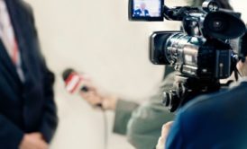 videographer recording a tv news broadcast