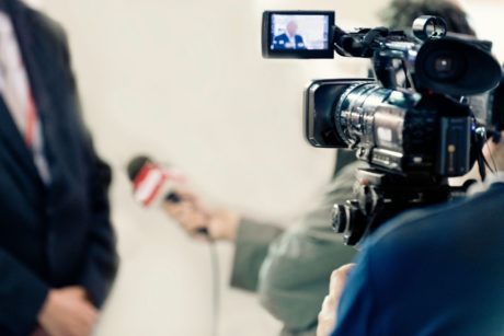 videographer recording a tv news broadcast