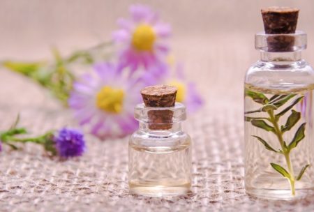 lavender flowers and aromatherapy oil in vials