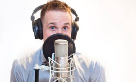 voice actor talking on microphone