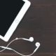 tablet and earphones on wooden table, used for iPad music production